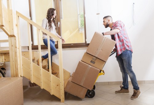 Local packing setup for a flat move with boxes, tape, and protective wrapping